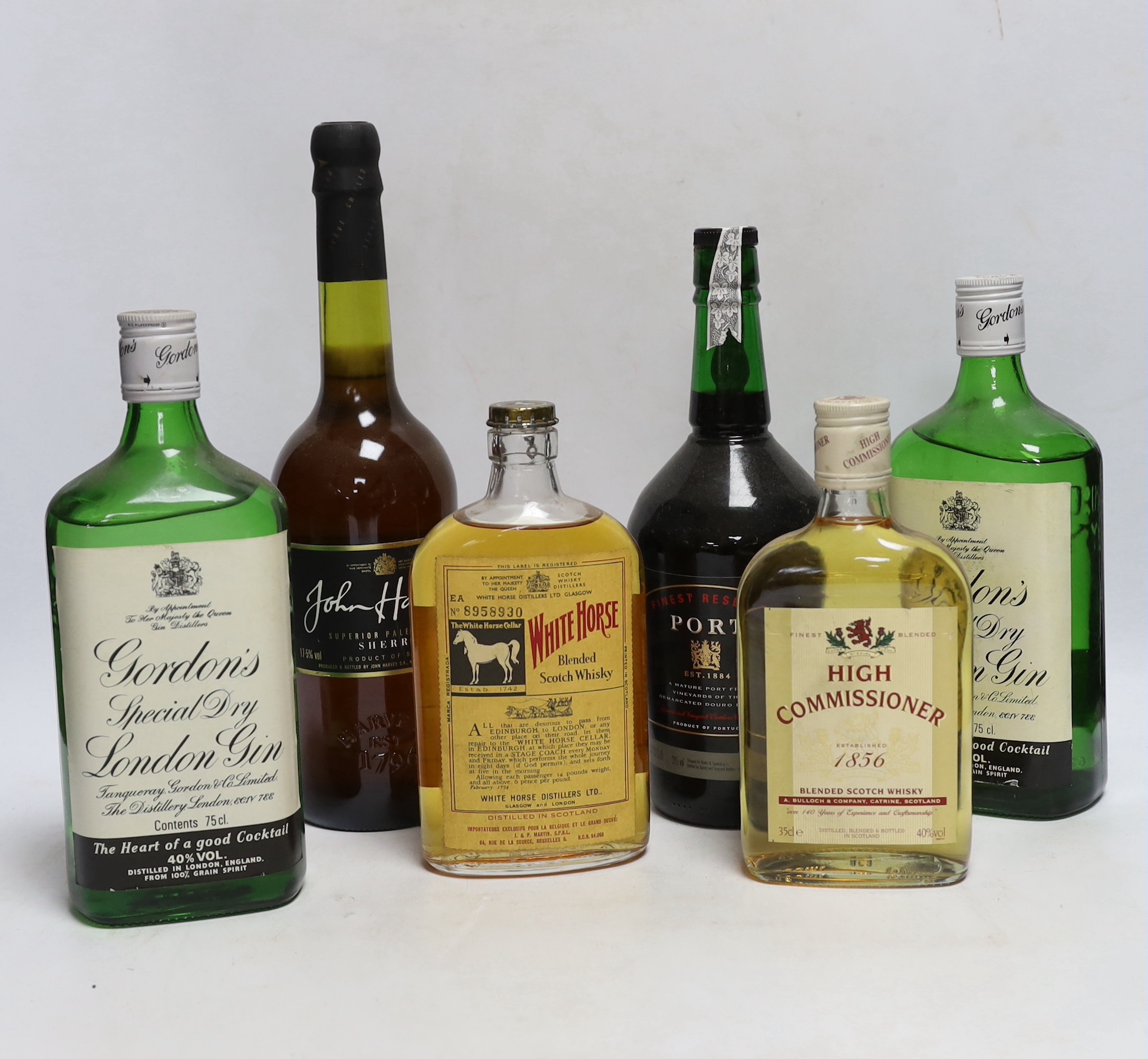 Two 75cl bottles of Gordons gin, two 35cl bottles of whisky, a bottle of sherry and a bottle of port